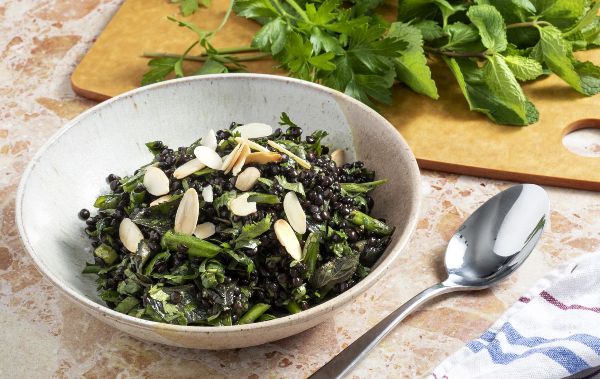 Black Lentil salad with fresh green herbs and tosted almonds
