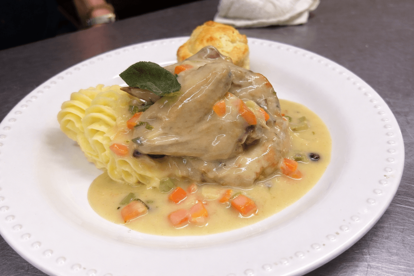 Chicken braised with cranberry and sage.