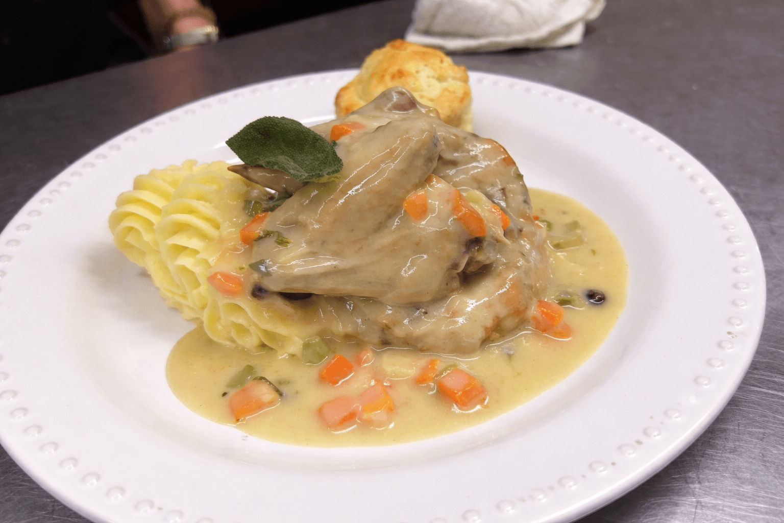 Chicken braised with cranberry and sage.