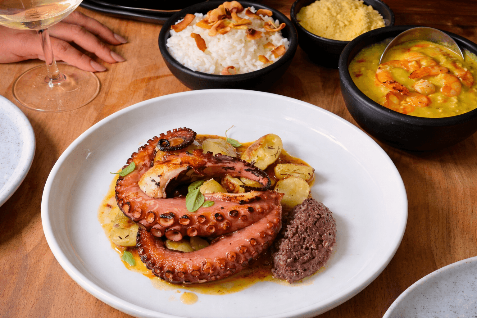 Grilled octopus with roasted baby potatoes and herb garnish
