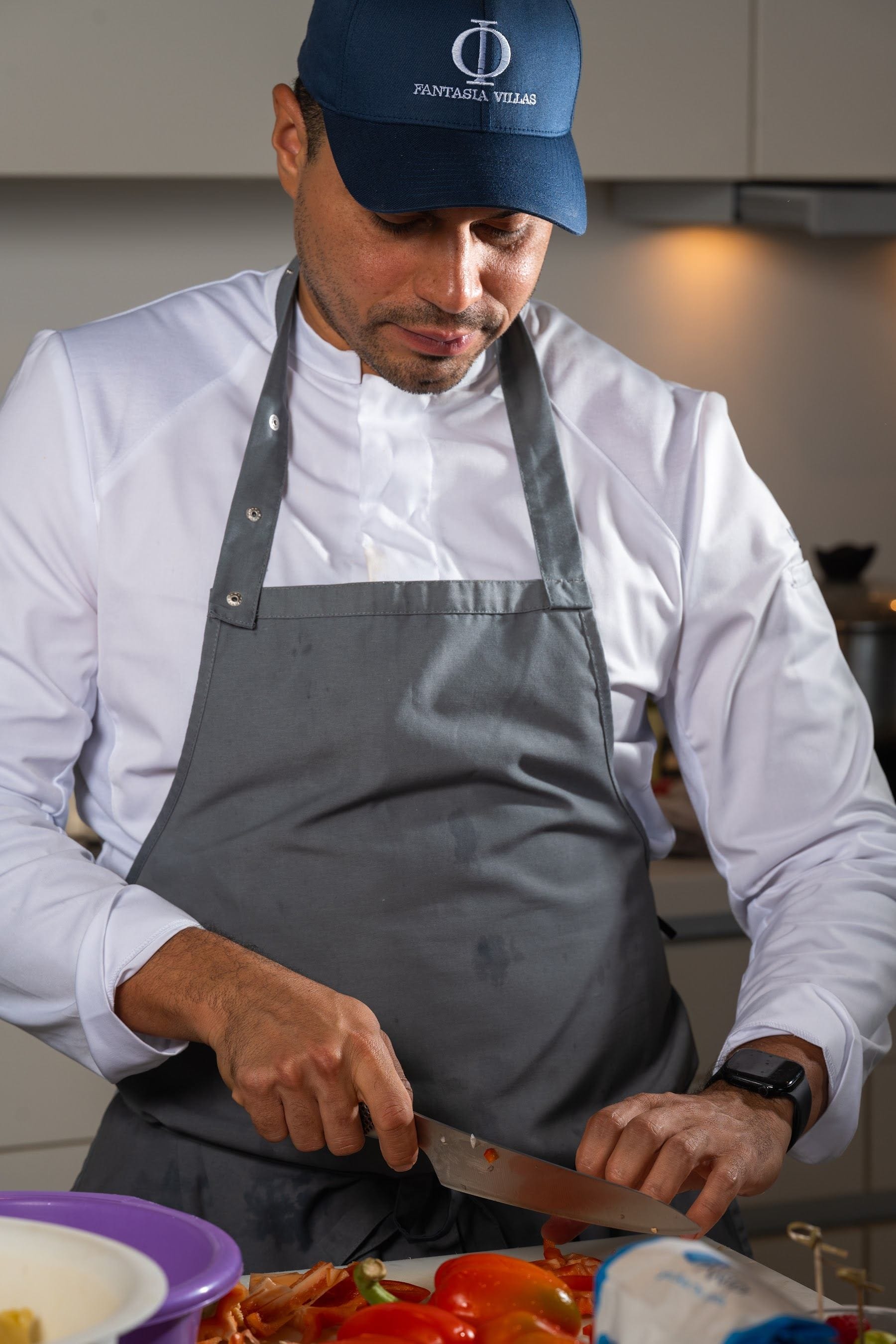 Private chef finishing a dish in the villa kitchen
