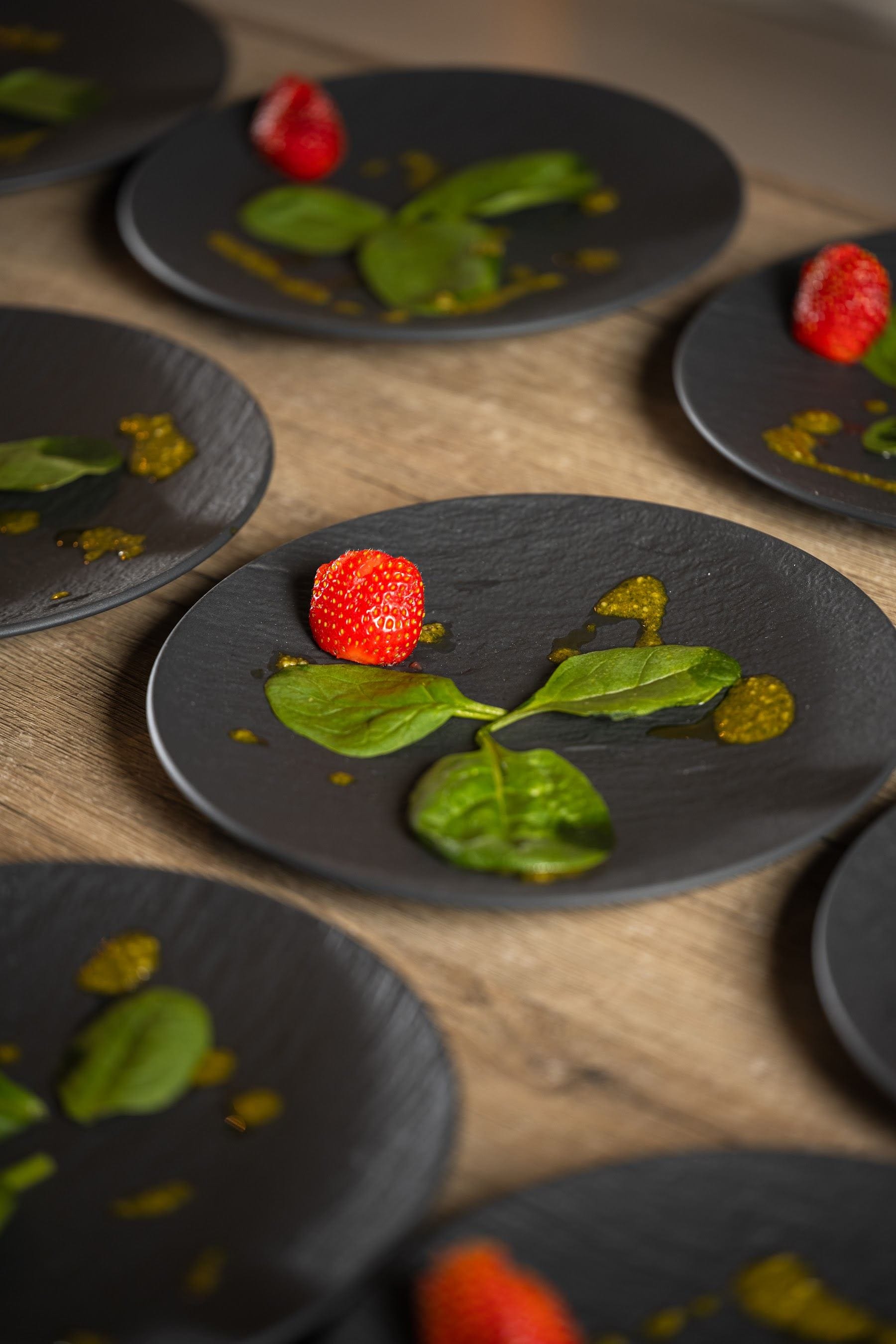 Amuse-bouche of strawberry and basil on black slate