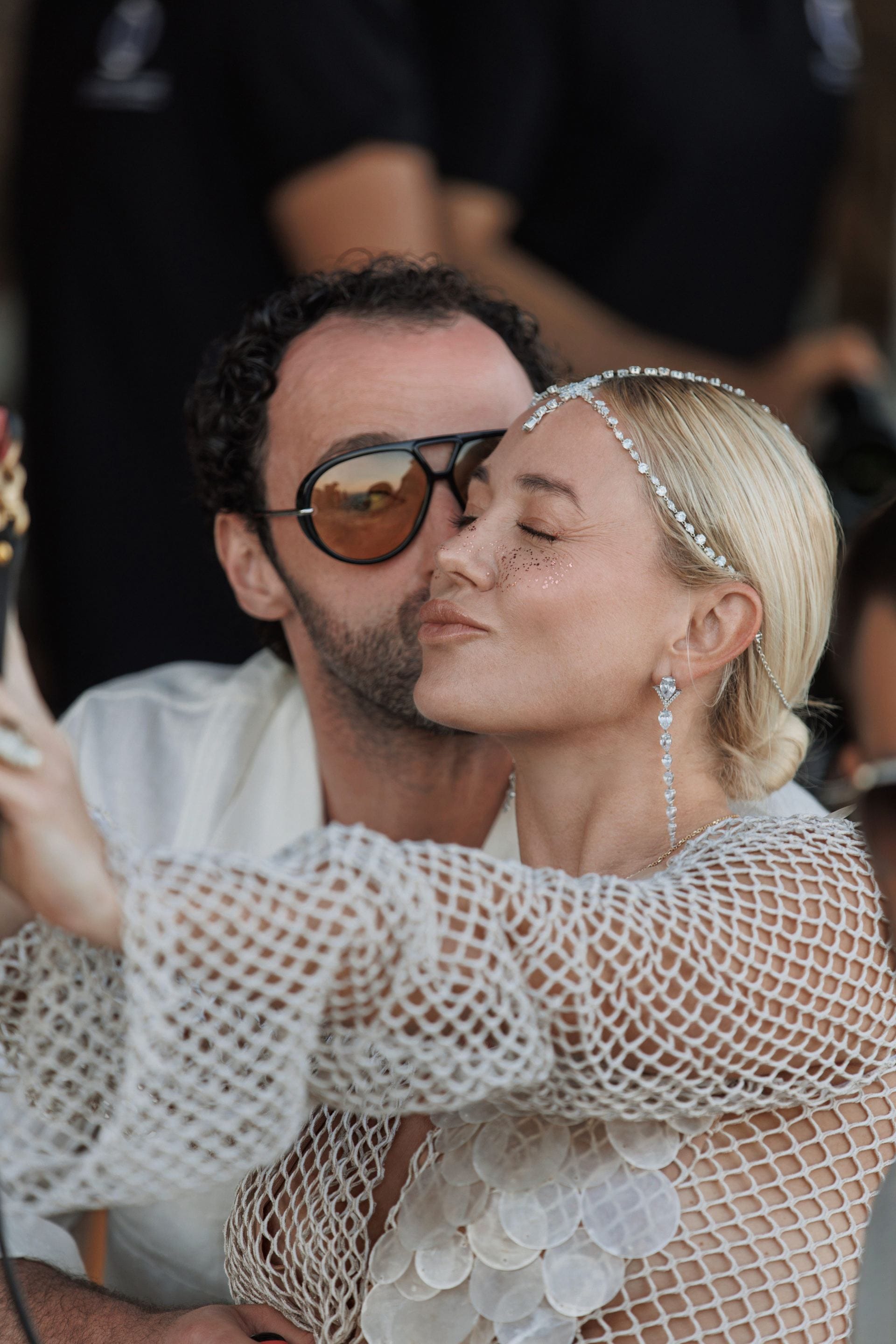 Couple sharing an affectionate moment at a stylish private villa event.