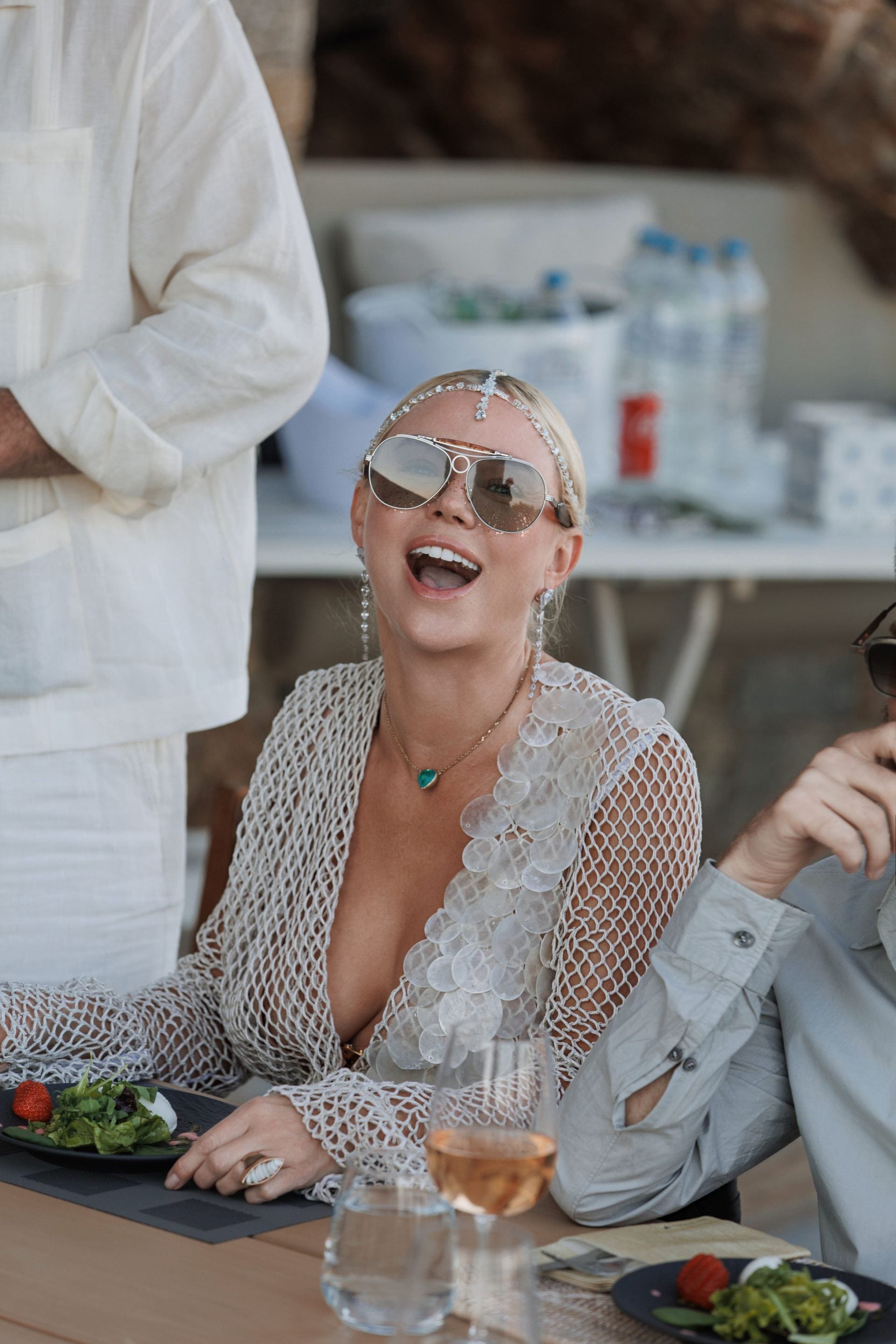 Guest enjoying lunch and rosé at a stylish private villa gathering.