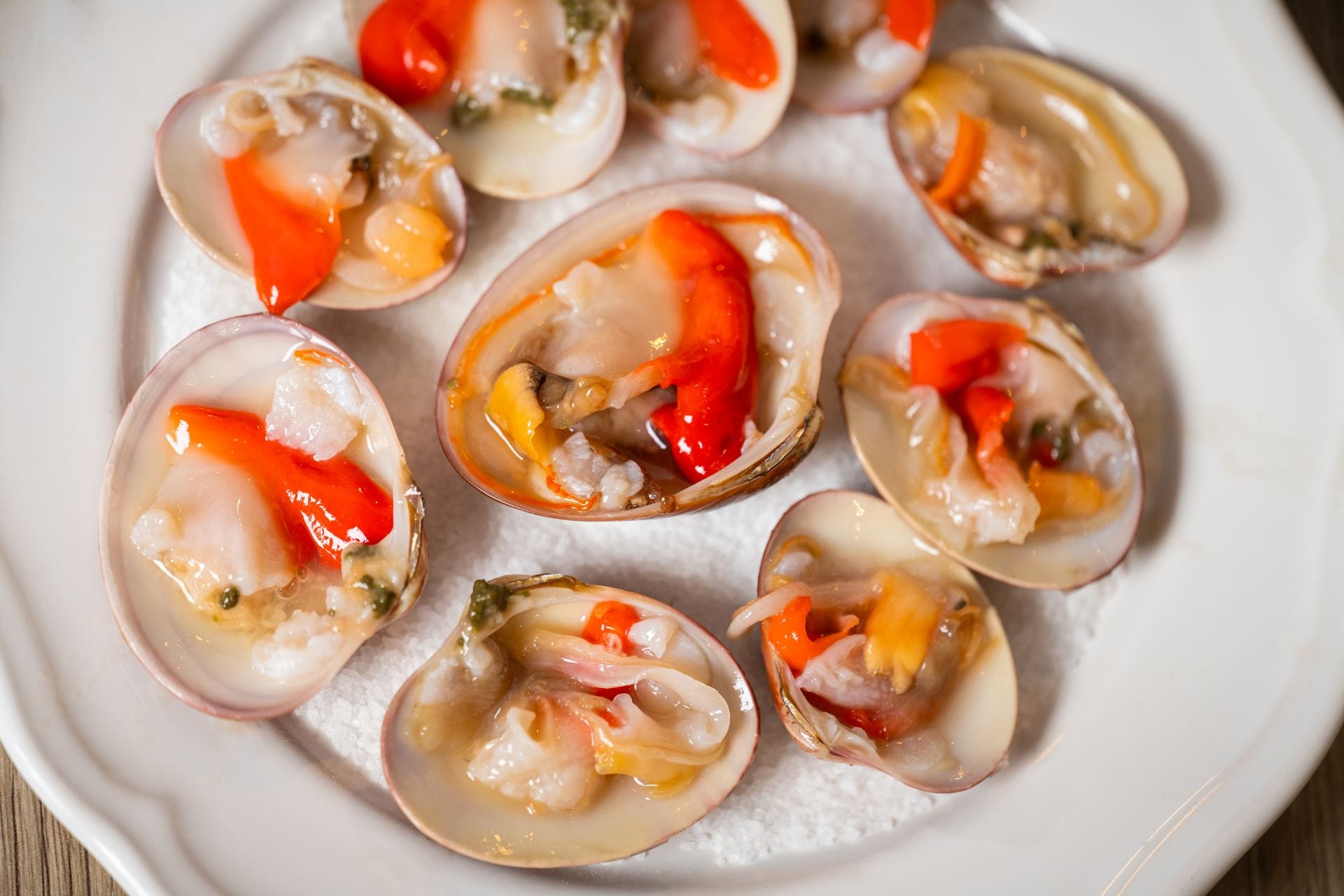 Fresh clams served on ice with a vibrant citrus dressing.