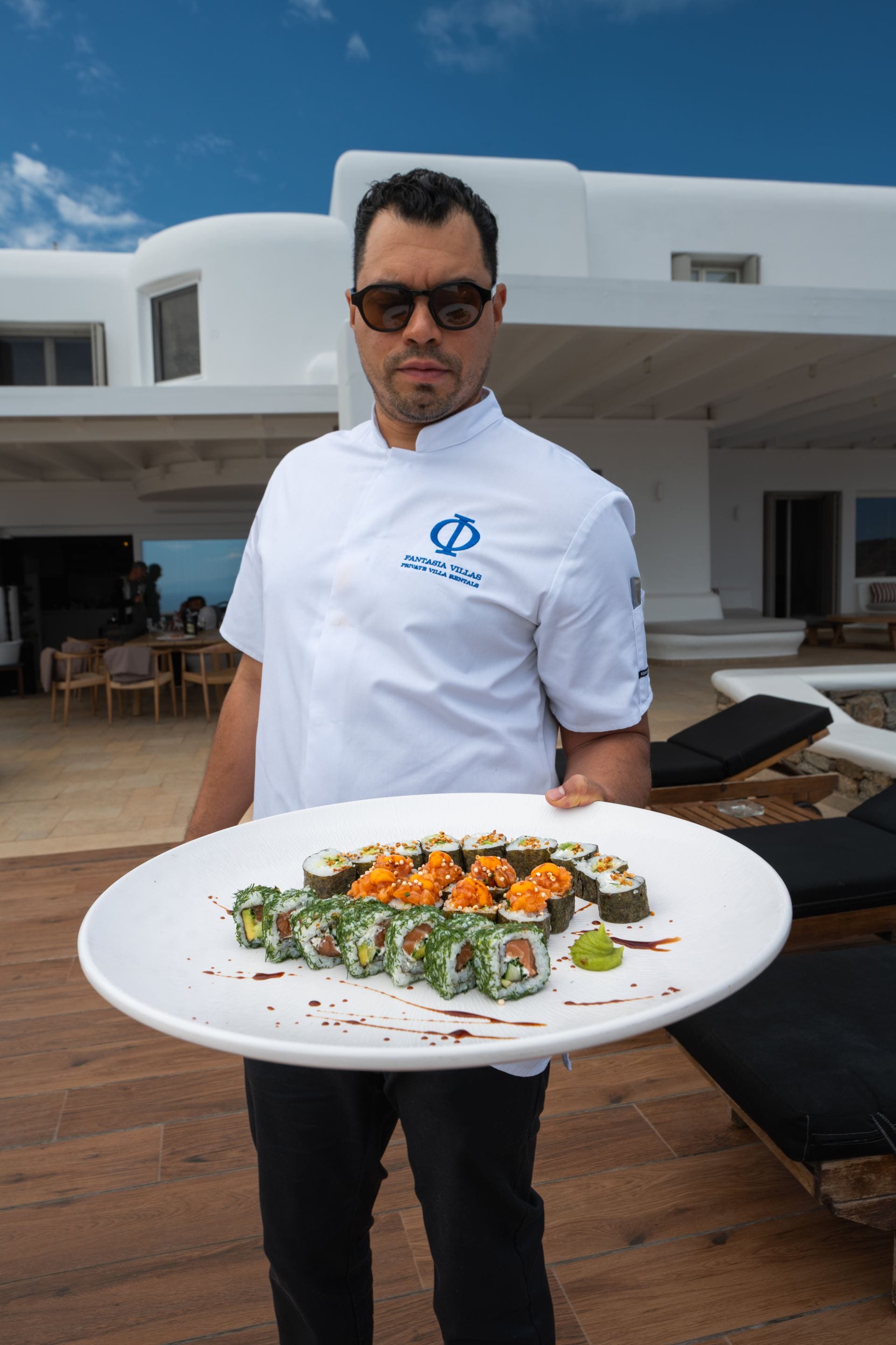 Fantasia Villas private chef serving freshly prepared sushi at a luxury villa.