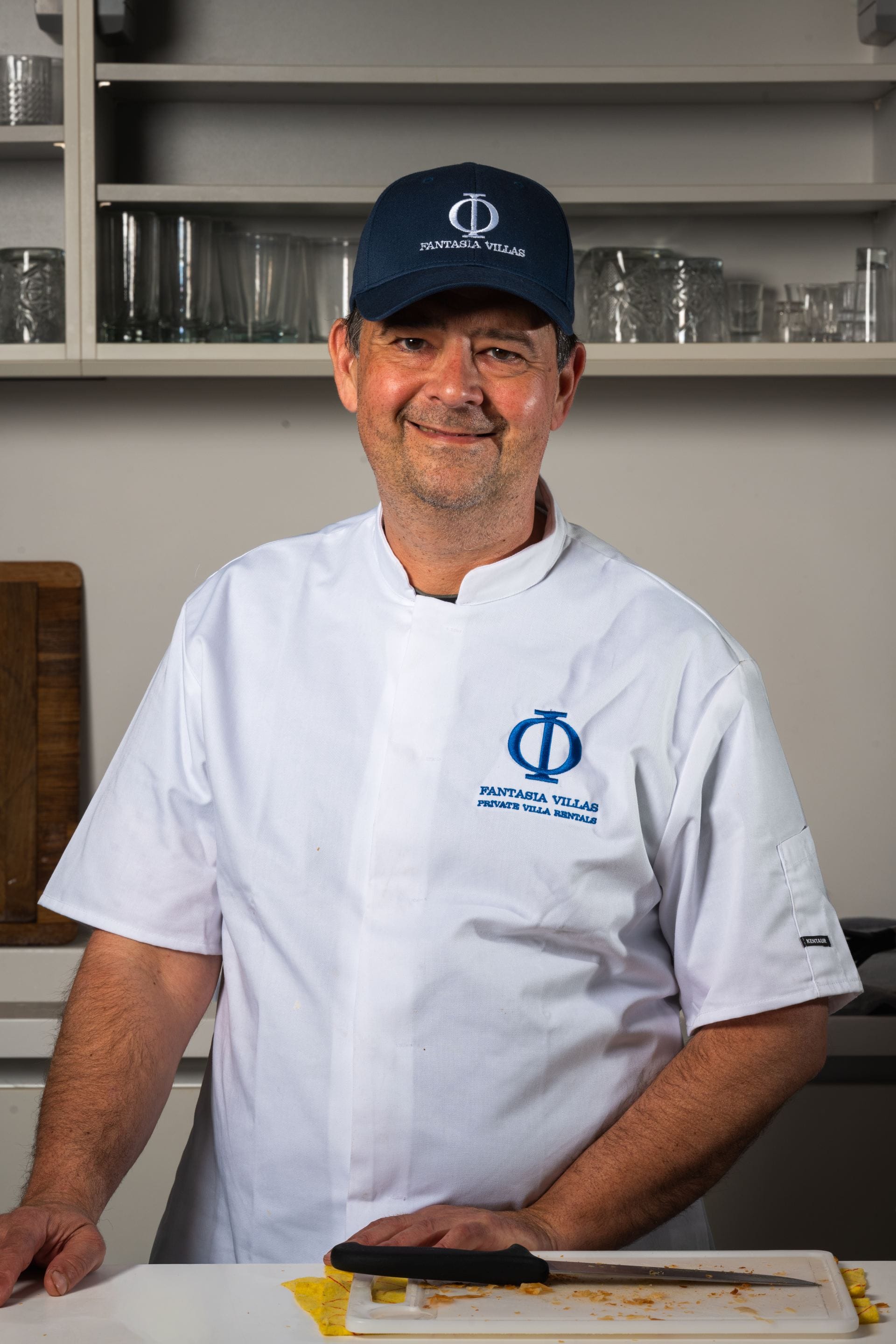 Fantasia Villas private chef in a branded uniform and cap.