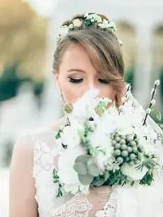 Bride holding a white floral bouquet